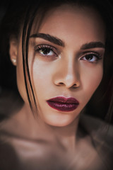 Close-up portrait of french model. Young beautiful woman mixed race.