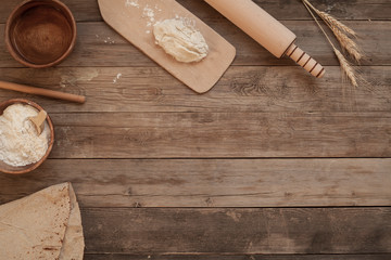 Fototapeta na wymiar bread and flour on wooden background