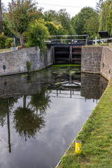 water lock on the river surrounded by trees and other plants