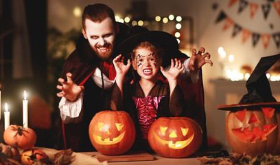 happy family   father and child daughter in costumes and makeup on  Halloween.