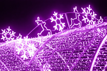 Christmas deers and snowflakes in neon violet color.