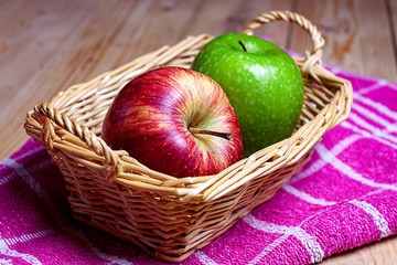 FIRST FLAT OF GREEN AND RED APPLES IN WICKER BASKET ON KITCHEN CLOTH 2. HEALTHY FOOD