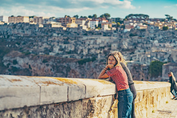 happy tourist travelling in south of italy, posing in a selfie photo in Matera, Basilicata, unesco...