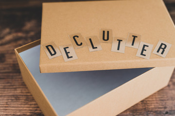 declutter message on top of semi-open empty box to fill with items to give away