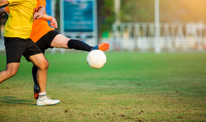 Soccer players control the ball for shoot to goal. Soccer players fighting each other by kicking the ball.