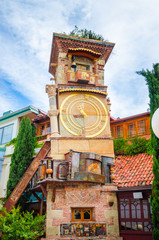 Fototapeta na wymiar Beautiful Clock Tower of puppet theater Rezo Gabriadze in historical center of old Tbilisi, Georgia