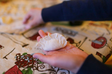 women holding a dumpling ready to cook