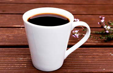 a coffee cup put on wooden outdoor