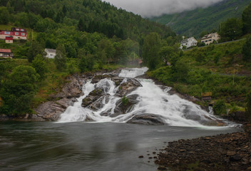 HELLESYLT, NORWAY - JULY 2019: Hellesyltfossen is one of many Norwegian waterfalls in the area Geirangerfjord in village Hellesylt. Long exposure shot.