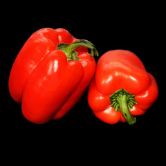 Bell pepper on black background. Two red peppers. Isolated backdrop. Macro. Closeup.  Vegetables. Organic food.
