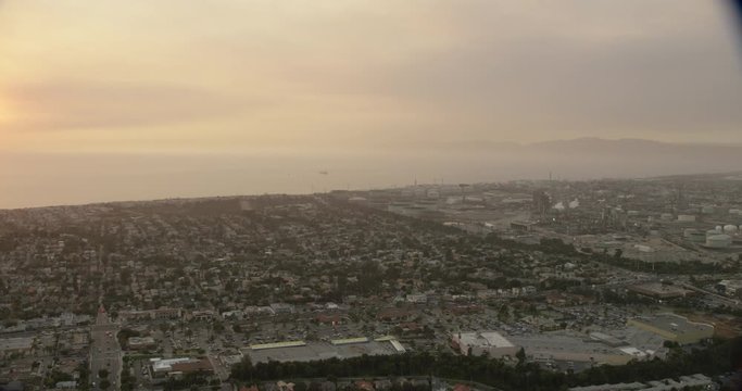 Aerial shot, day, high altitude rotating view of coastal la neighborhood at sunset, drone