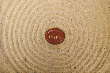 Fototapeta na wymiar health rock on sand - very zen