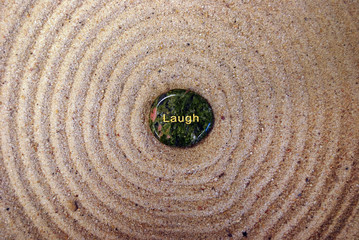 Fototapeta na wymiar Laugh Rock on Sand - Very Zen
