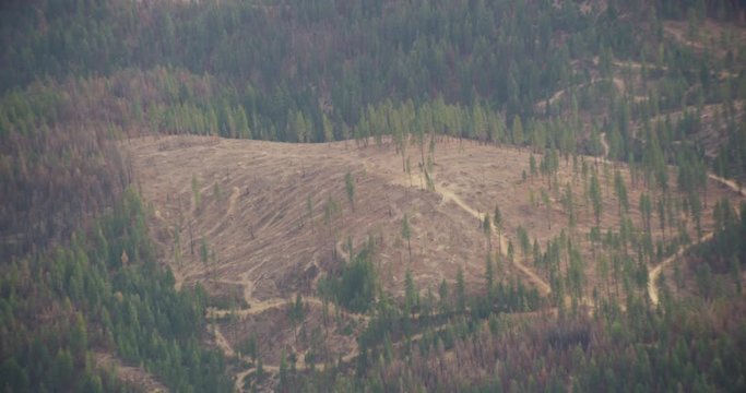 Aerial shot, day, zoom barren spot in california mountain range, drone