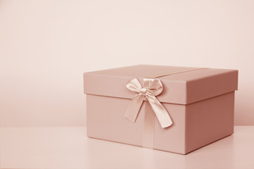 gift in box with satin ribbon and bow, concept of valentines day, christmas presents, mother's day, new year, close-up, copy space