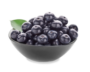 Bowl with fresh acai berries on white background