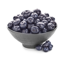 Bowl with fresh acai berries on white background