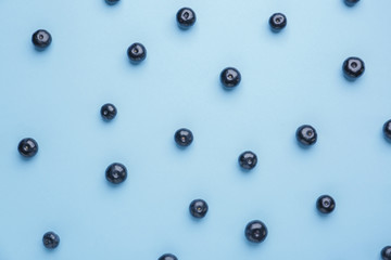 Fresh acai berries on color background