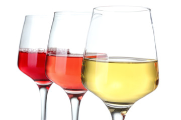 Glasses of different wine on white background