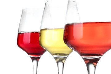 Glasses of different wine on white background