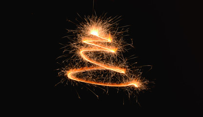 Shining spiral made of sparklers on dark background