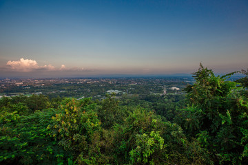 Obraz premium Natural panoramic scenery background, which can see the surrounding atmosphere (trees, green leaves, mountains, fog, soft sunlight, colorful sky) with blurred wind blowing, cool air