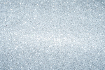 Silver Sparkling Lights Festive background with texture. Abstract Christmas twinkled bright bokeh defocused and Falling stars. Winter Card or invitation