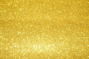 gold Sparkling Lights Festive background with texture. Abstract Christmas twinkled bright bokeh defocused and Falling stars. Winter Card or invitation