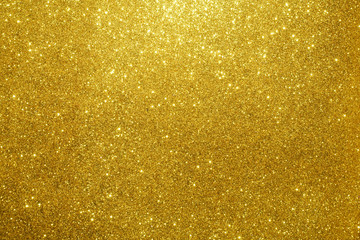 gold Sparkling Lights Festive background with texture. Abstract Christmas twinkled bright bokeh...