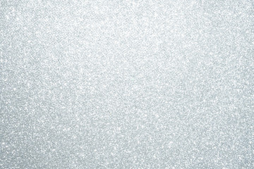 Silver Sparkling Lights Festive background with texture. Abstract Christmas twinkled bright bokeh defocused and Falling stars. Winter Card or invitation