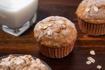 Oatmeal Raisin Muffin with a Glass of Milk on a Wood Table