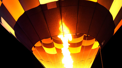close up of hot air balloon burner flame glowing at night