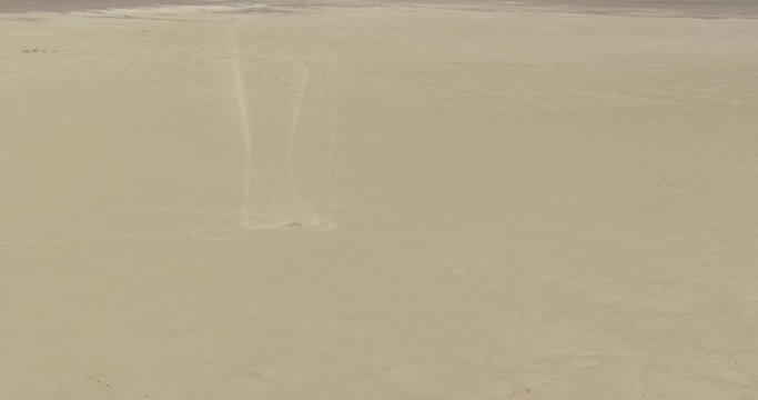 Helicopter aerial shot zooming into perfect circle dug out of desert lands, drone