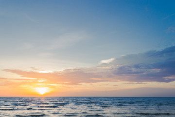 Naklejka na ściany i meble sunset sky over sea in the evening with beautiful sunlight