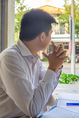 Fototapeta premium Asian businessman sitting and thinking about work