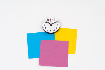 Blank colorful post-it with clock time at ten minute past ten
