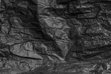 Fototapeta premium Crumpled black paper use for background