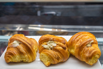 Tasty butter croissant with cream cheese inside at pastry shop