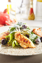 Warm salad with grilled chicken breast fillet