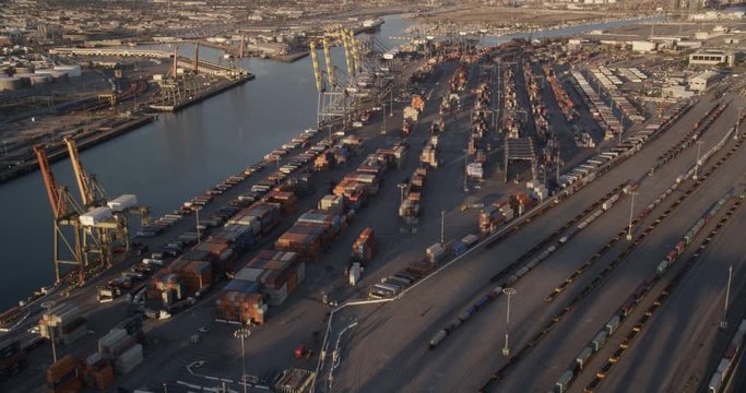 Aerial shot, pan over shipping port at sun down, drone