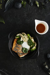 Beautiful Serving Branzino or Seabass Fillet with Bisque Sauce and Spinach Top View