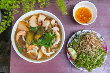 Bowl of traditional Vietnamese roasted pork and shrimp noodles soup 