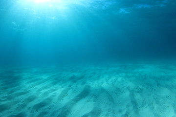 Fototapeta na wymiar Blue underwater background photo of sea and sand 