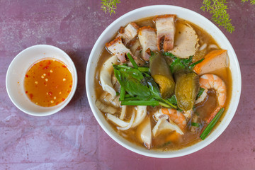 Bowl of colorful and delicious Vietnamese seafood noodles soup