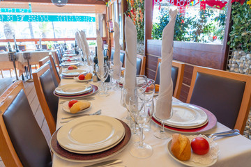 Beautiful banquet table setting with wine glass and tableware