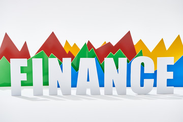 multicolor statistic graphs behind finance inscription on white background