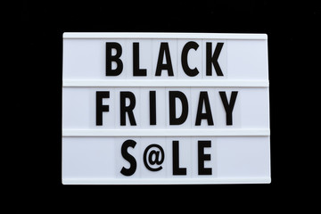 Creative promotion composition Black friday sale text on lightbox on black background. Flat lay, top view, overhead, mockup