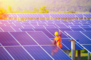 Engineer team with solar panel in solar power plant, electrician is repairing, changing solar panel,concept of sustainable resources.