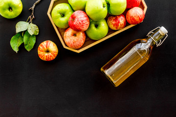 Vinegar made from fresh apple on black background top view space for text
