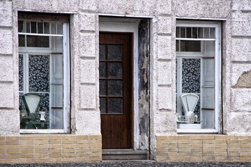 Old shop facade with pair of windows and door